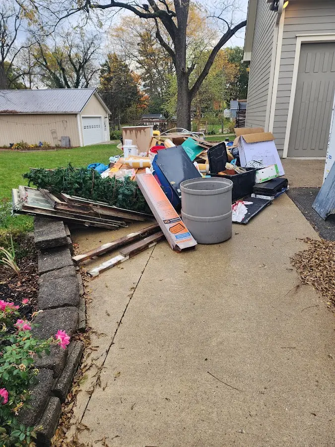 Dumpster being loaded with debris for Roofing Dumpster Rental in New Boston